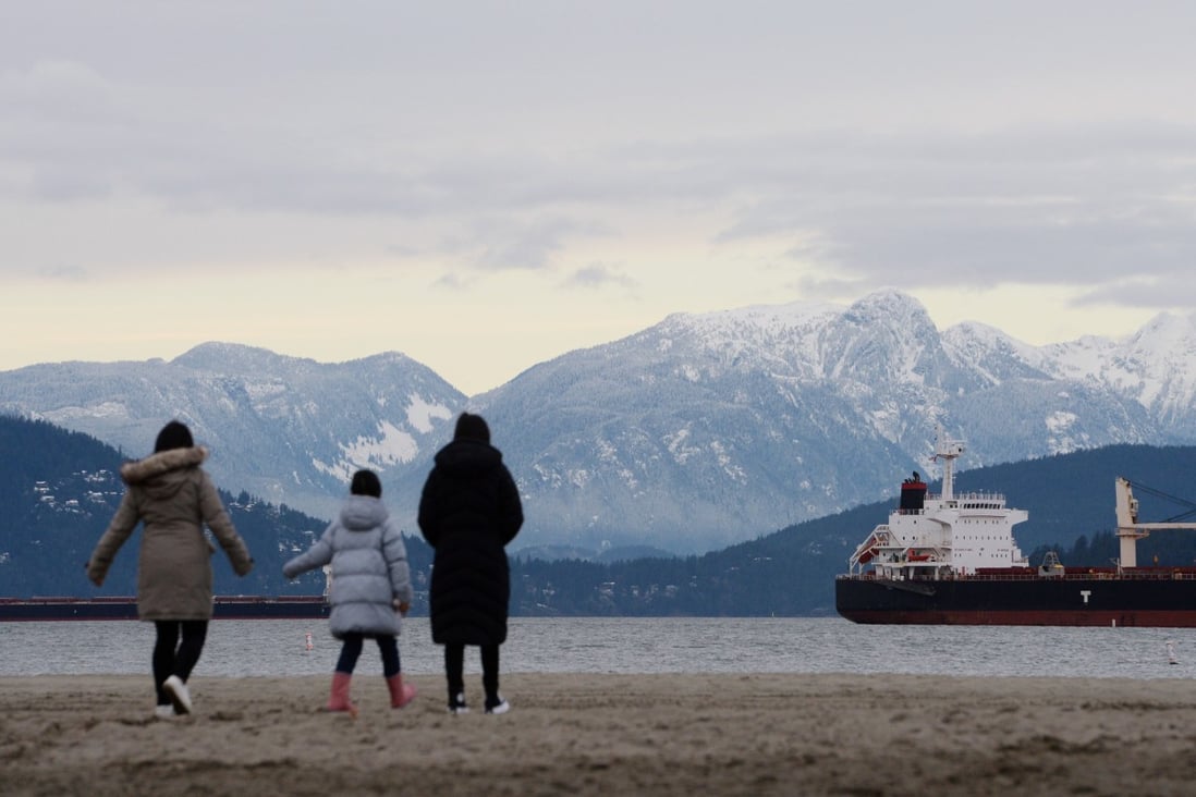 A family of Hong Kong immigrants walk along Jericho Beach in Vancouver, British Columbia on January 26. Photo: Reuters