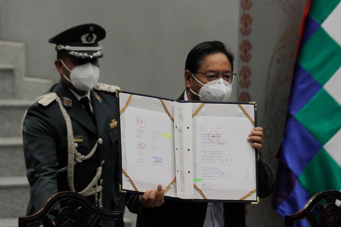 Bolivian President Luis Arce (right) shows an agreement signed with China for the supply of pharmaceutical firm Sinopharm’s Covid-19 vaccine in La Paz on Thursday. Photo: Xinhua