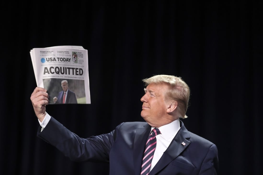 Donald Trump holds a copy of the USA Today newspaper headline with his impeachment acquittal on Saturday. Photo: EPA-EFE