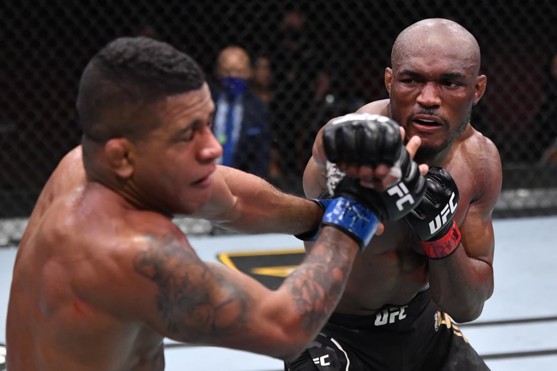 Kamaru Usman punches Gilbert Burns in their UFC welterweight championship fight during UFC 258. Photos: Jeff Bottari/Zuffa LLC
