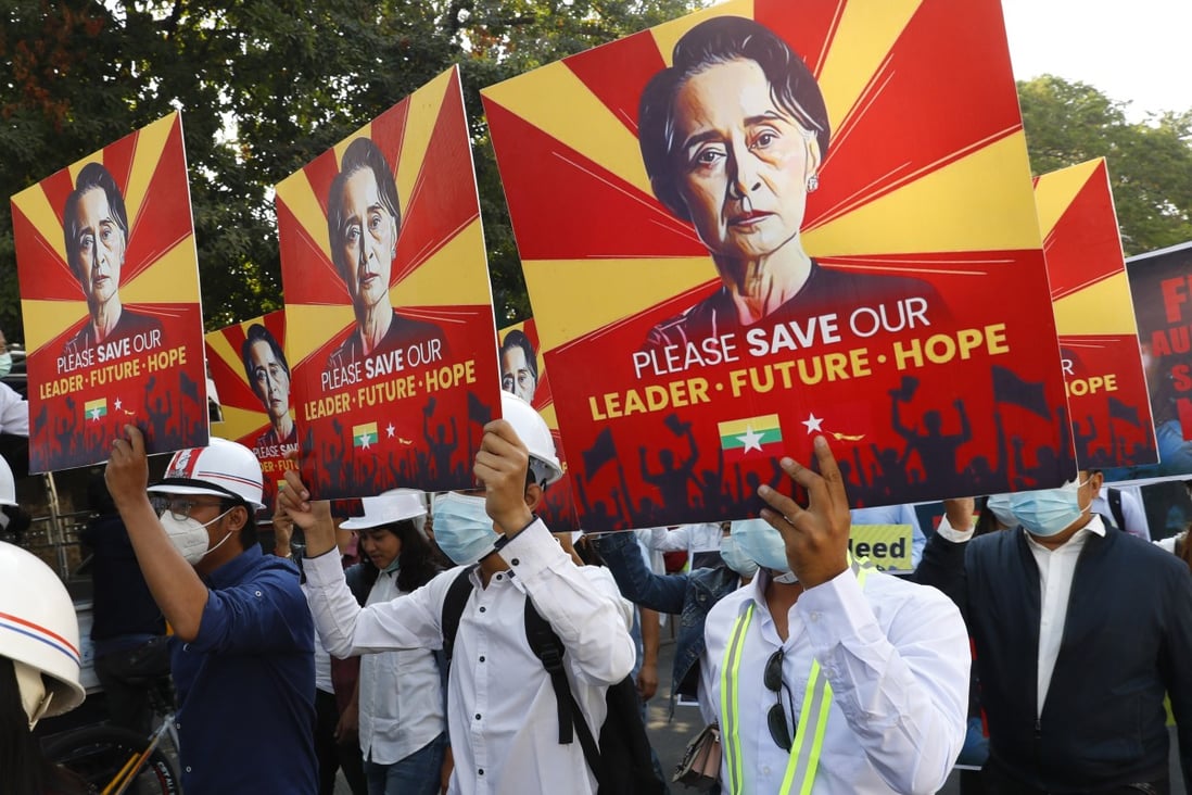 Engineers hold posters with an image of deposed Myanmar leader Aung San Suu Kyi as they hold an anti-coup protest march. Photo: AP
