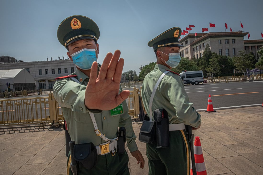 A People’s Liberation Army soldier tries to stop a photographer from taking photos at Tiananmen Square during the Communist Party's annual congress in Beijing on May 28, 2020. The events at Tiananmen Square in 1989 remain one of the most widely censored topics in China. Photo: EPA-EFE