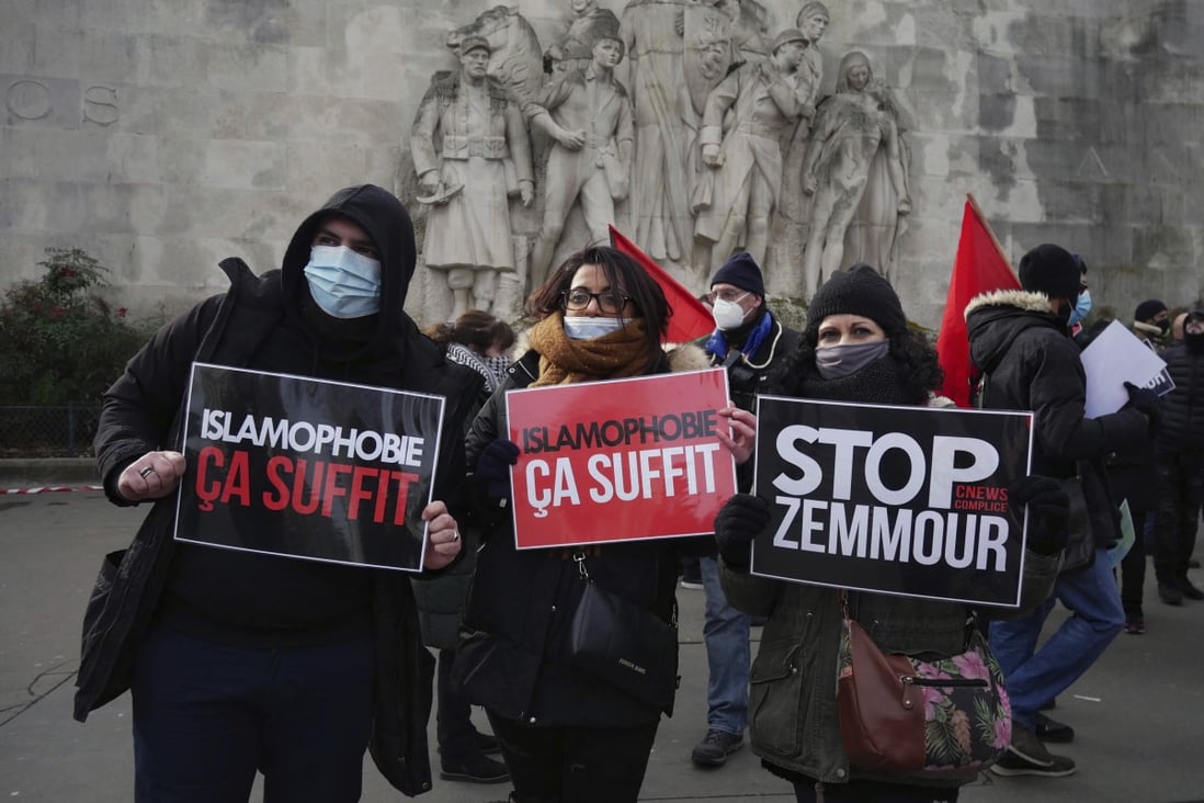 Activists hold anti-Islamophobia placards in Paris on Sunday. Photo: AP
