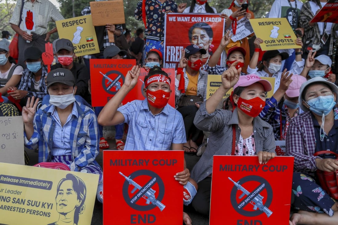 Demonstrators display pictures of deposed Myanmar leader Aung San Suu Kyi as they protest against the military coup, in Yangon on February 18. Photo: AP