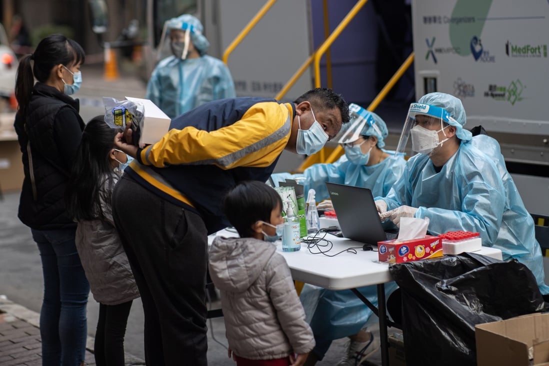 Residents register for Covid-19 tests at a mobile testing station in Hong Kong. The city has reached purchase agreements for three coronavirus vaccines. Photo: EPA-EFE