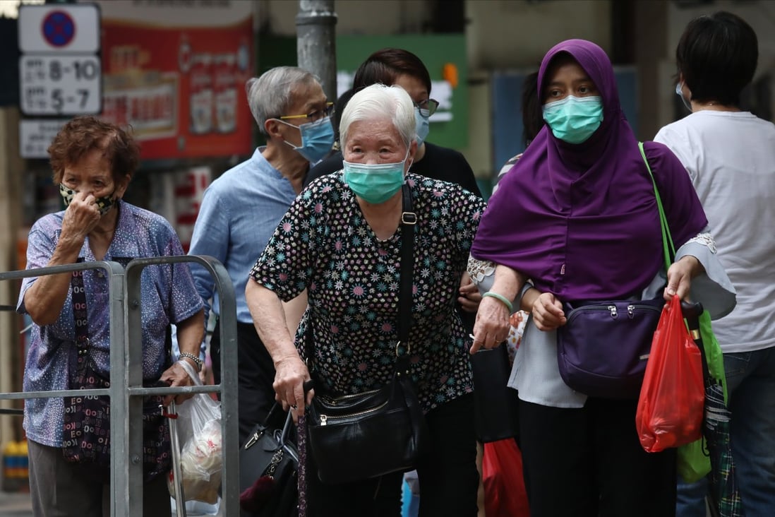 An elderly woman crosses the street with her domestic helper in Hong Kong. Non-western societies tend to have a general belief in not placing aged family members in care homes. Photo: Jonathan Wong