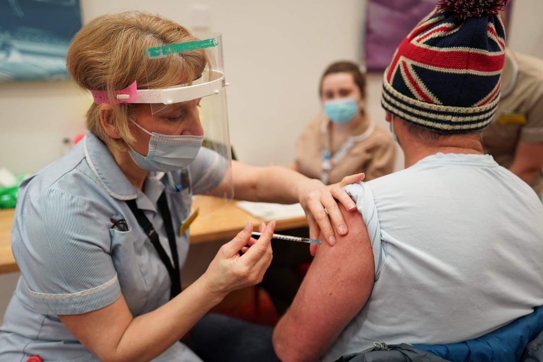A key worker receives a Covid-19 shot in England. Photo: AFP