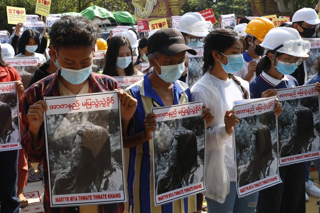 Mandalay University graduates hold up images of Mya Thwet Thwet Khine, who was shot in the head by police on February 9. Photo: AP