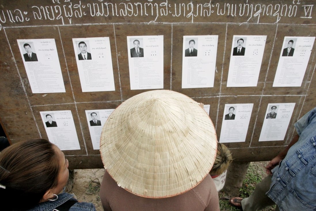 Laotians look at candidates’ pictures at a polling station during the general election in 2006. Photo: Reuters