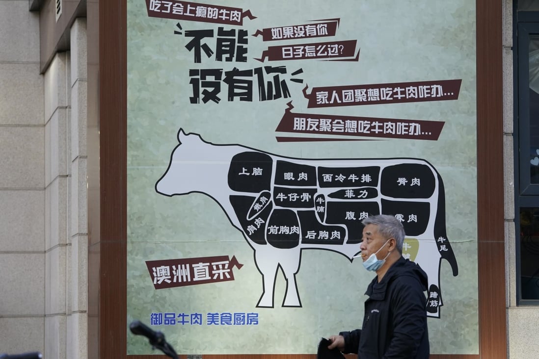 A man in Beijing walks by an advertisment promoting imported beef from Australia. The Australian beef trade with China had a tumultuous 2020 due to the trade suspensions of five processing plants. Photo: AP