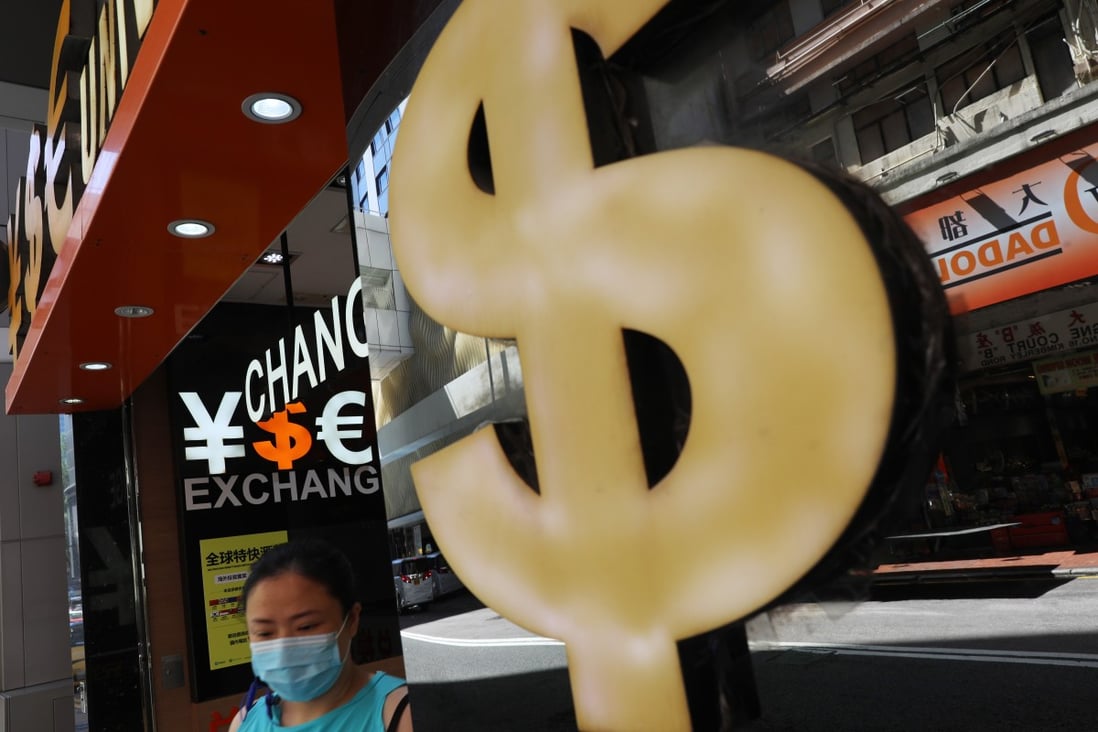 A woman leaves a currency exchange booth in Tsim Sha Tsui in June 2020. Hong Kong’s dollar peg has allowed the government to be too passive, even when assets are bubbling in plain sight. Photo: Sam Tsang