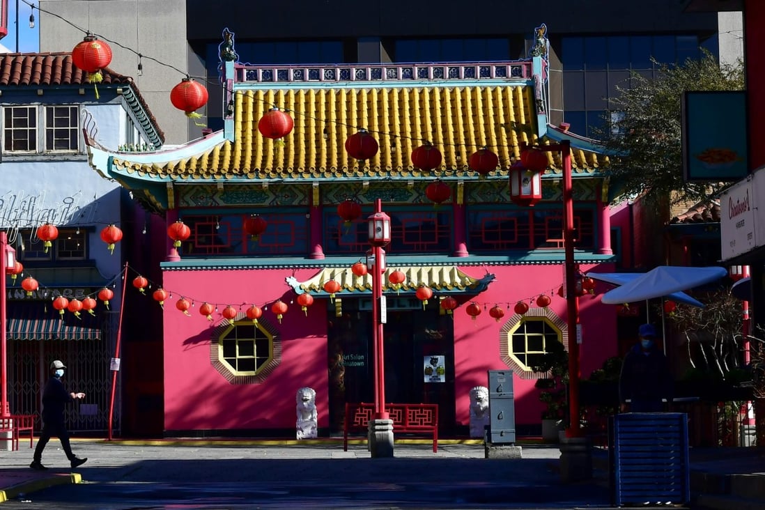 A pedestrian wearing a face mask walks across a deserted Chinatown Central Plaza in Los Angeles, where many businesses remain closed due to the coronavirus pandemic, on the first day of the Lunar New Year on February 12. Photo: AFP