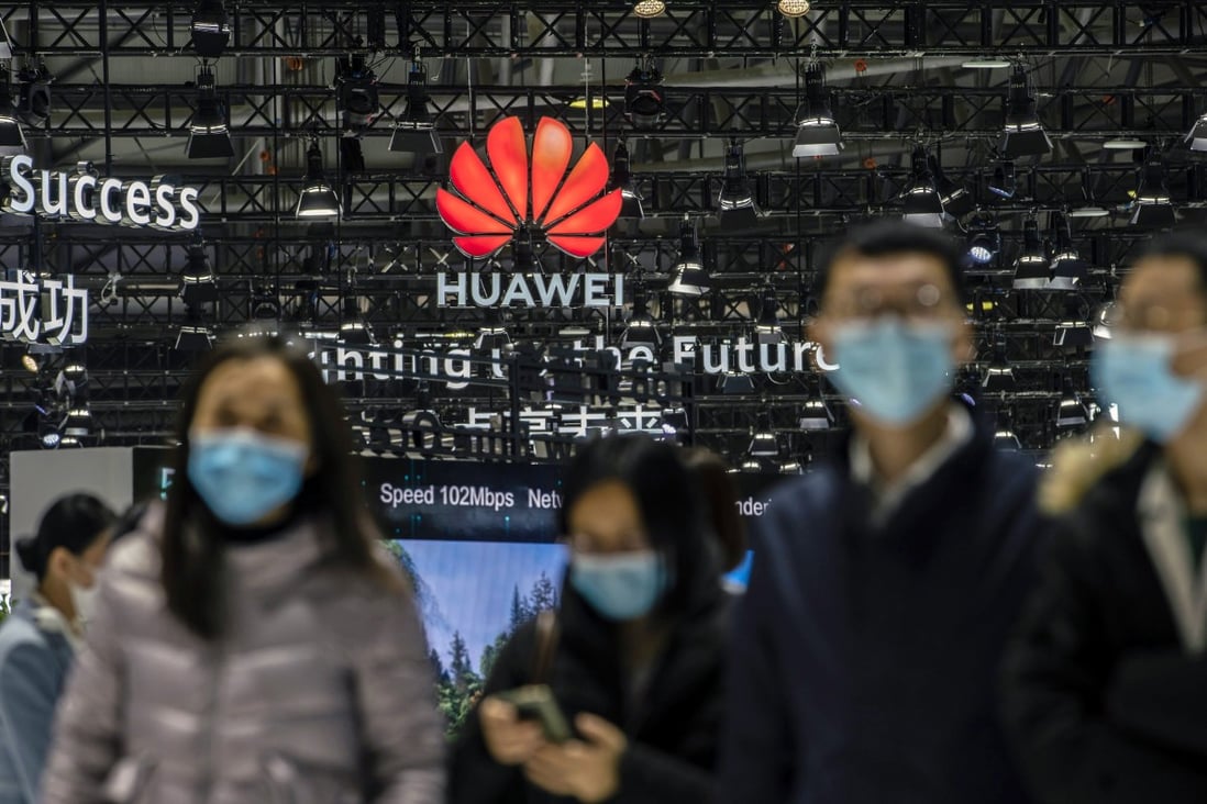 Attendees walk past Huawei Technologies Co’s signage at the opening of telecommunications industry trade show MWC Shanghai on February 23, 2021. Photo: Bloomberg