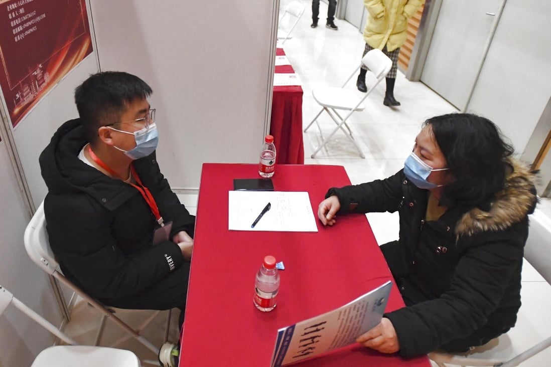 A recruiter speaks with an applicant at a job fair in Changsha, Hunan province, last week. A record-high 9.09 million university graduates will enter China’s job market this year. Photo: Xinhua