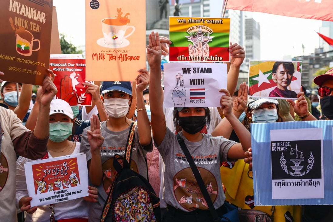Pro-democracy protesters holds signs relating to the #MilkTeaAlliance and the current situation in Myanmar as they take part in a demonstration in Bangkok on Sunday. Photo: AFP