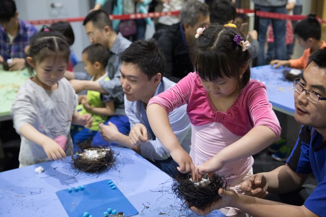 Children make birds’ nests with their parents at a scientific carnival in Beijing, where activities for families have become lucrative. Photo: Xinhua