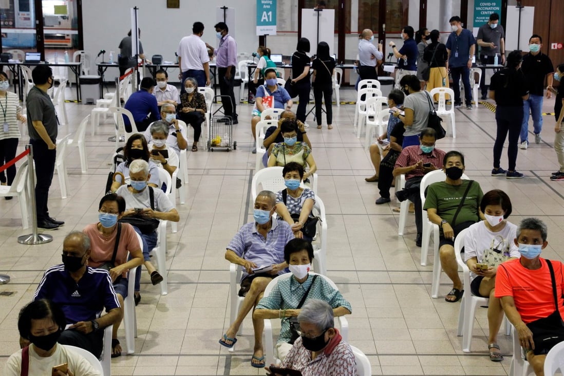 Elderly Singaporeans await their coronavirus shots at a vaccination centre in the city state. Photo: Reuters