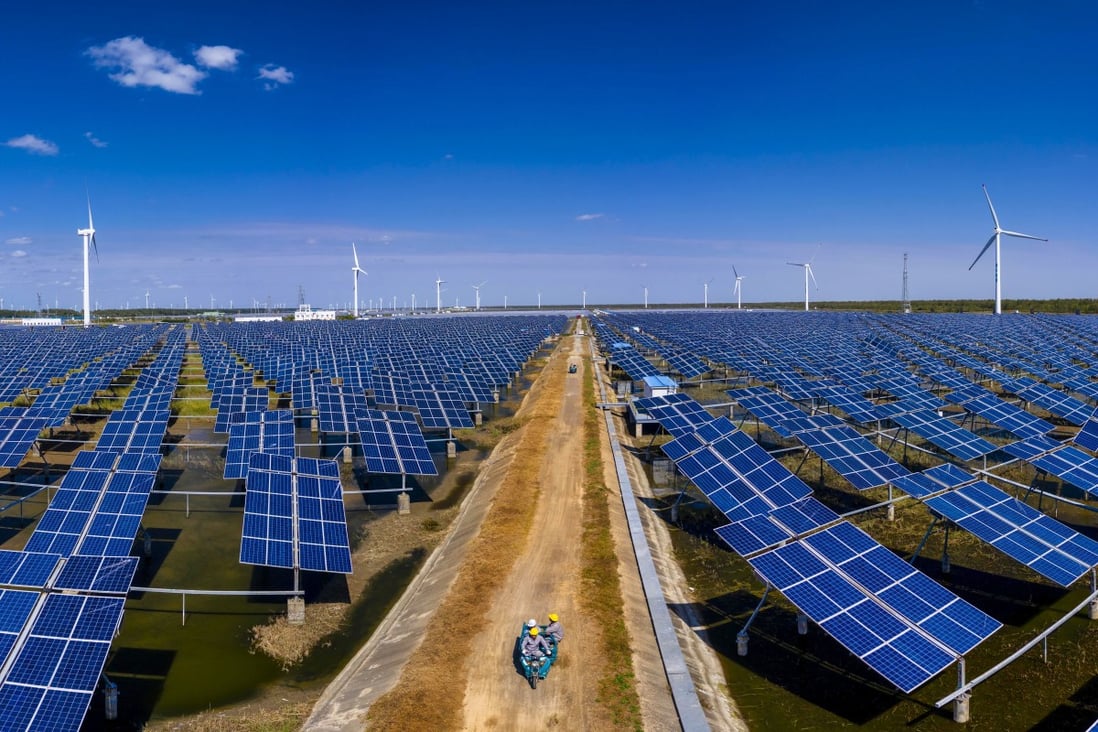 Solar panels and wind turbines cover this area near the city of Yancheng, in the eastern coastal province of Jiangsu. State Grid Corp of China plans to accelerate development of clean energy infrastructure, including wind and solar power for generating electricity. Photo: EPA-EFE