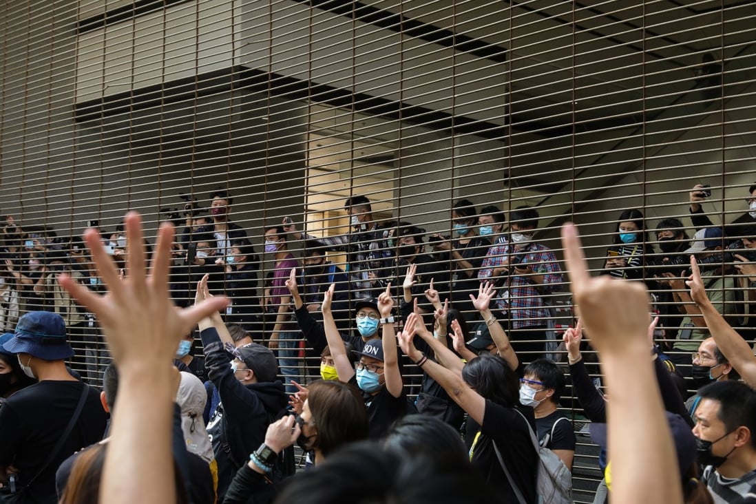 Supporters of the 47 former opposition lawmakers and activists gather and chant slogans outside the West Kowloon Court on Monday. Photo: Nora Tam