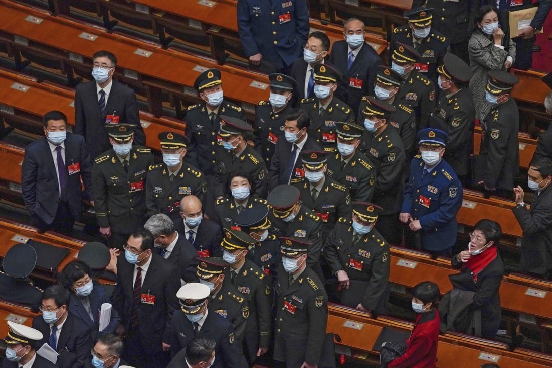 Military delegates leave the opening session of the National People’s Congress in Beijing on Friday. Photo: AP
