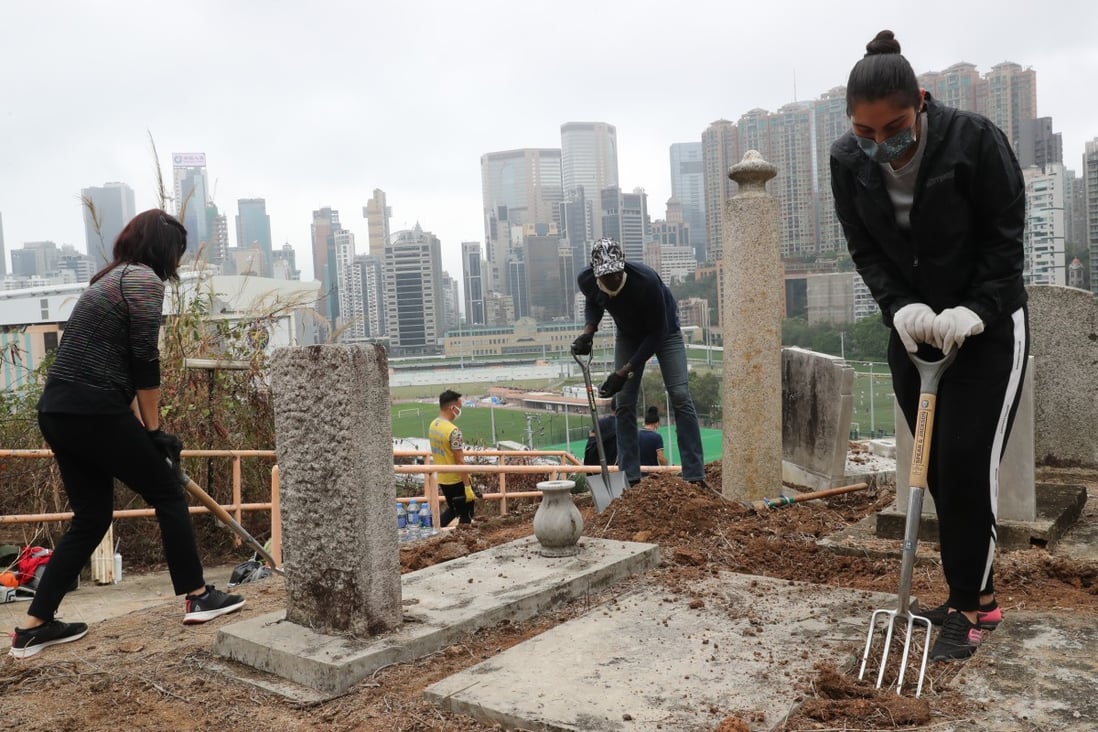 Volunteers working to clean up the historic cemetery. Photo: Edmond So