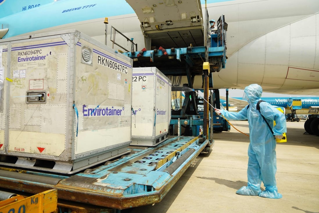 A health official sprays disinfectant on the first shipment of AstraZeneca/Oxford Covid-19 vaccines after its arrival in Ho Chi Minh City on February 24. Photo: AFP