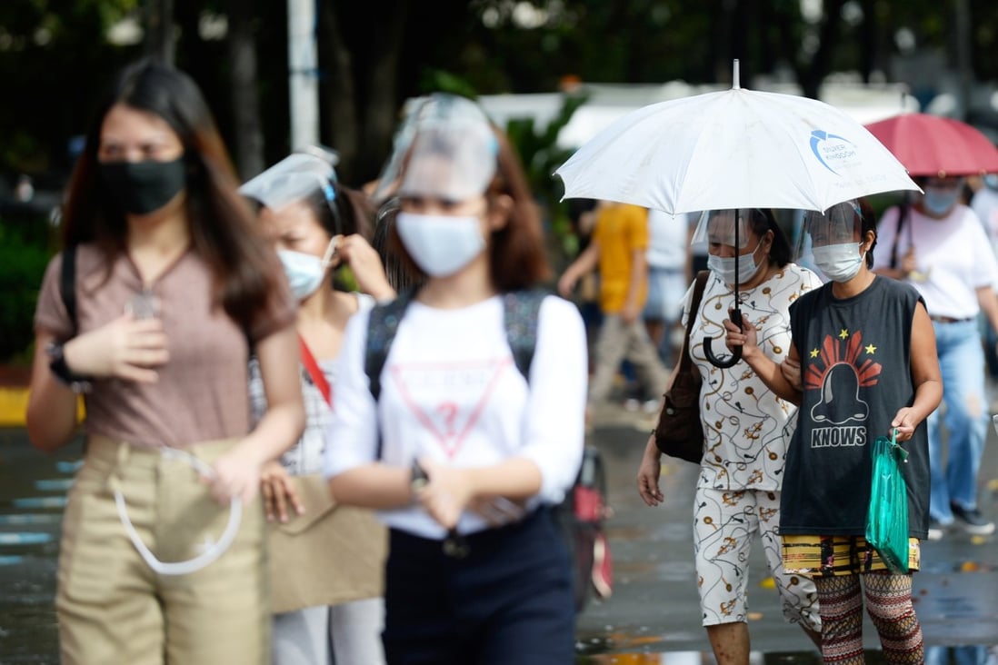 Women seen in face masks and face shields in Manila, Philippines. Photo: Reuters