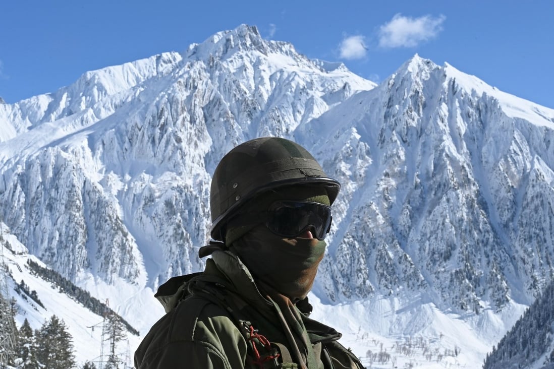An Indian soldier stands guard near a mountain pass that connects Srinagar to Ladakh, bordering China. Photo: AFP