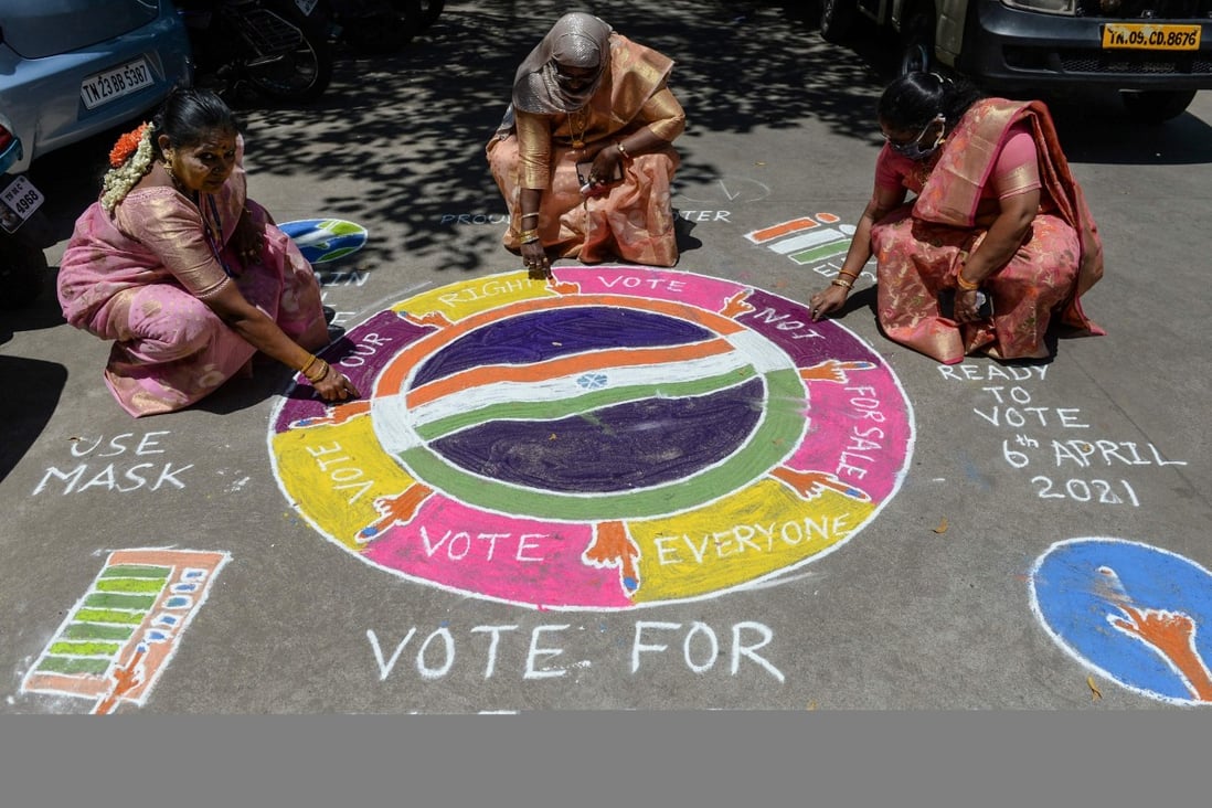 Electoral workers draw traditional folk-art designs urging residents of Chennai, Tamil Nadu, to vote in the coming legislative assembly elections. Photo: AFP
