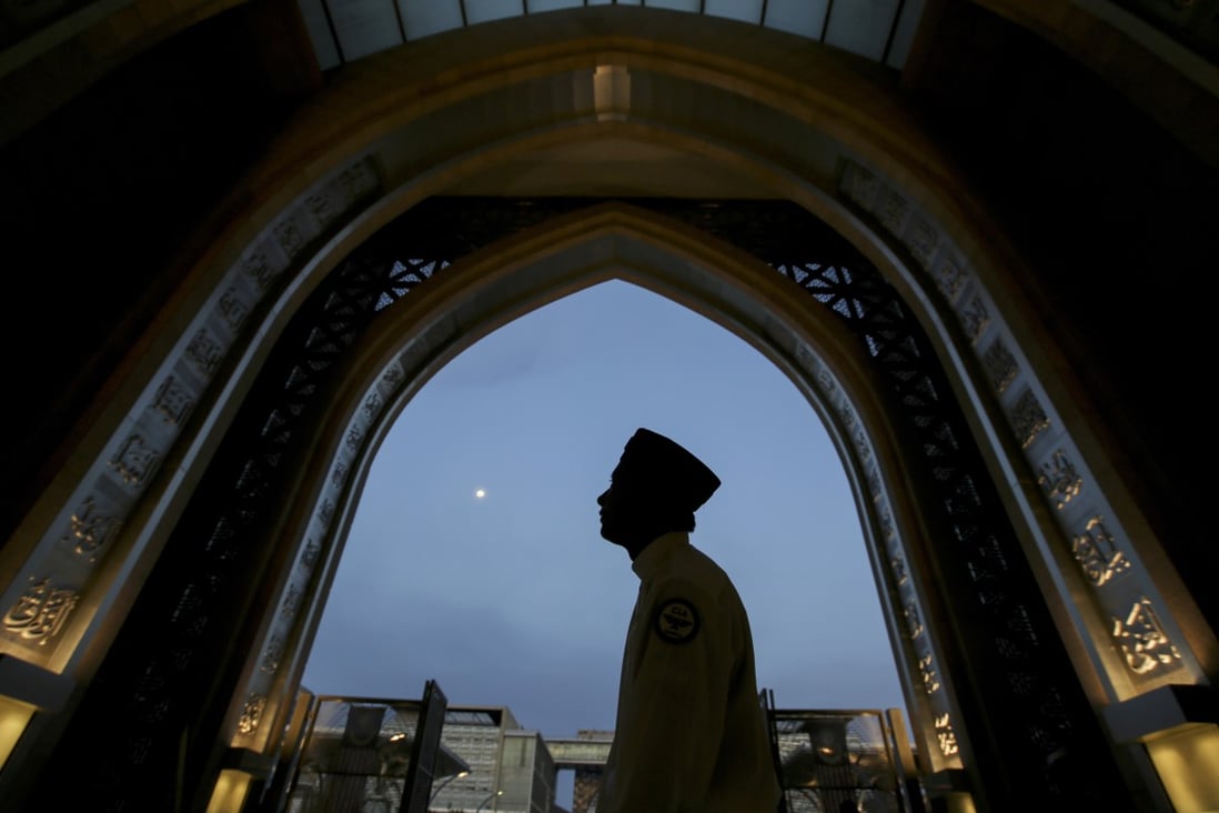 A worshipper arrives at a mosque in Kuala Lumpur during the holy Islamic month of Ramadan. Photo: AP