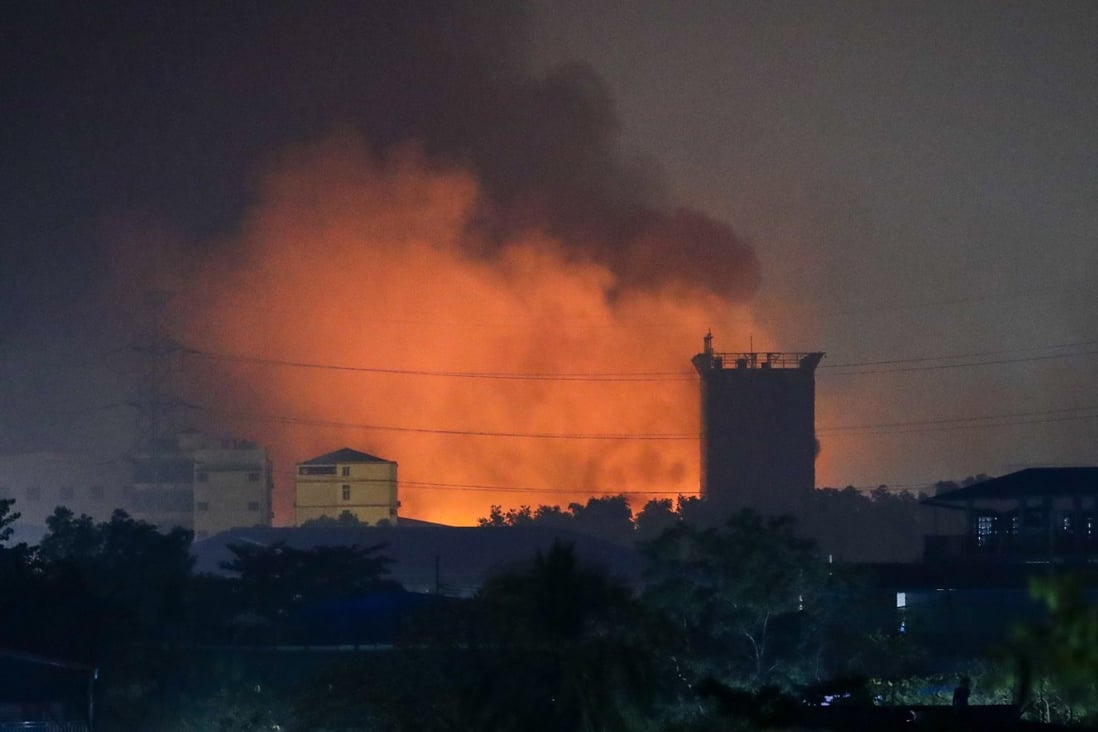 Fire from burning Chinese-owned factories in Myanmar’s industrial township of Hlaingthaya, on the outskirts of Yangon, is seen in the early hours of Monday morning. Photo: EPA