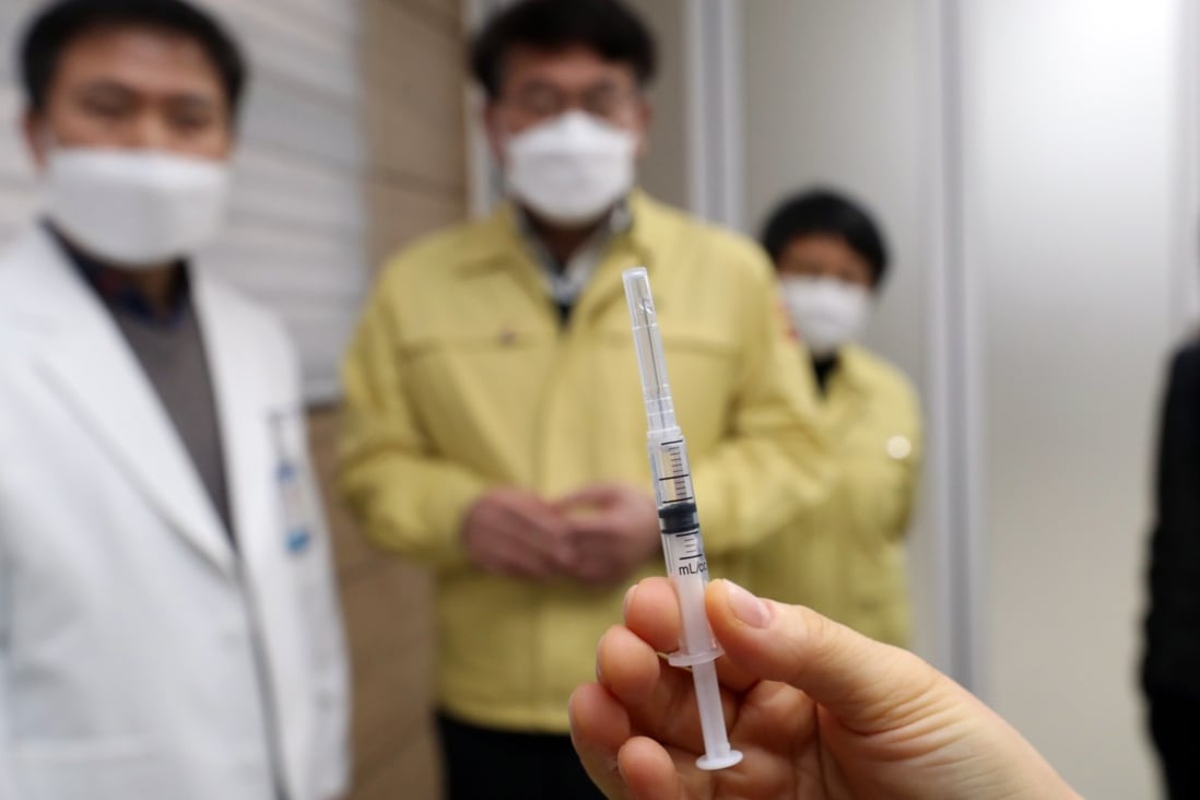 A medical worker in South Korea holds up a syringe containing AstraZeneca's Covid-19 vaccine. Photo: DPA