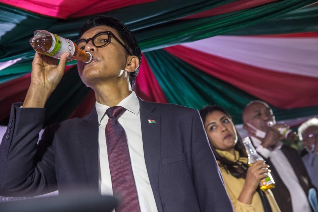 Madagascar's President Andry Rajoelina drinks a sample of ‘Covid Organics’ in April 2020. Photo: AFP