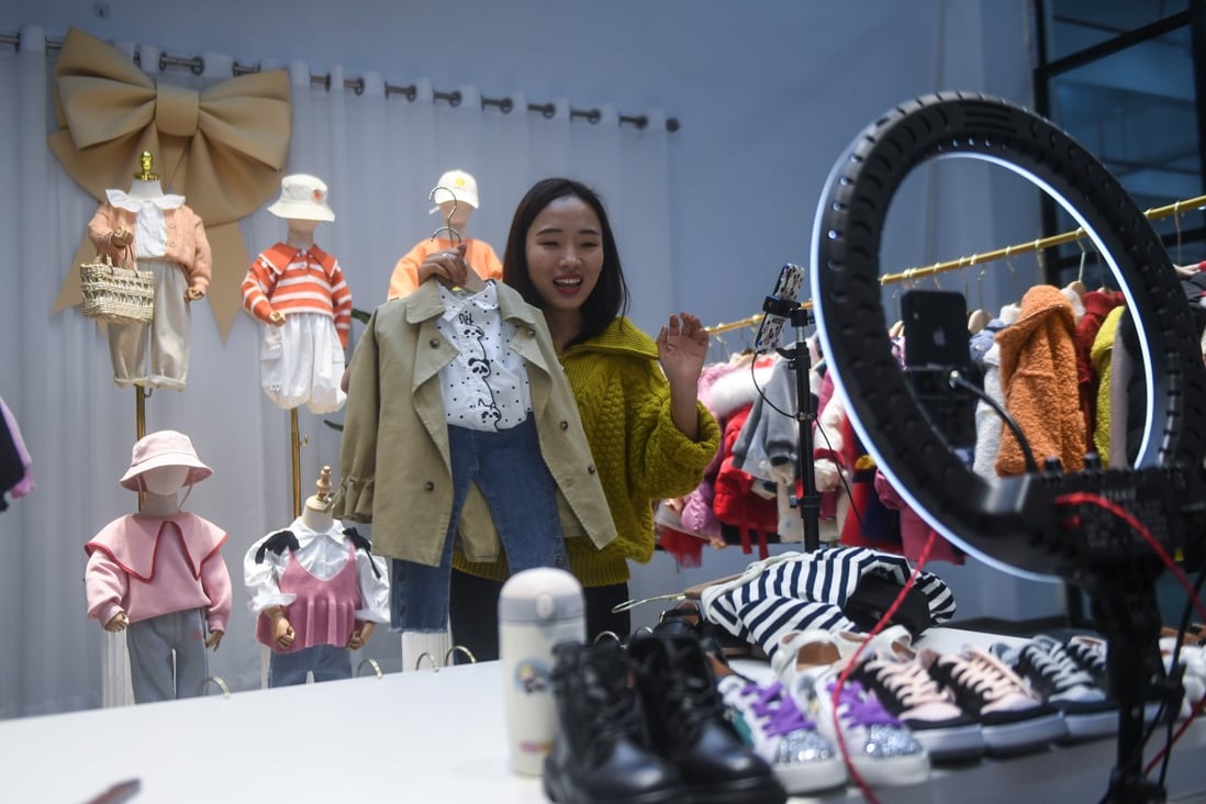 A woman sells children’s clothes on a live-stream in Huzhou, China, on February 8. Photo: Xinhua