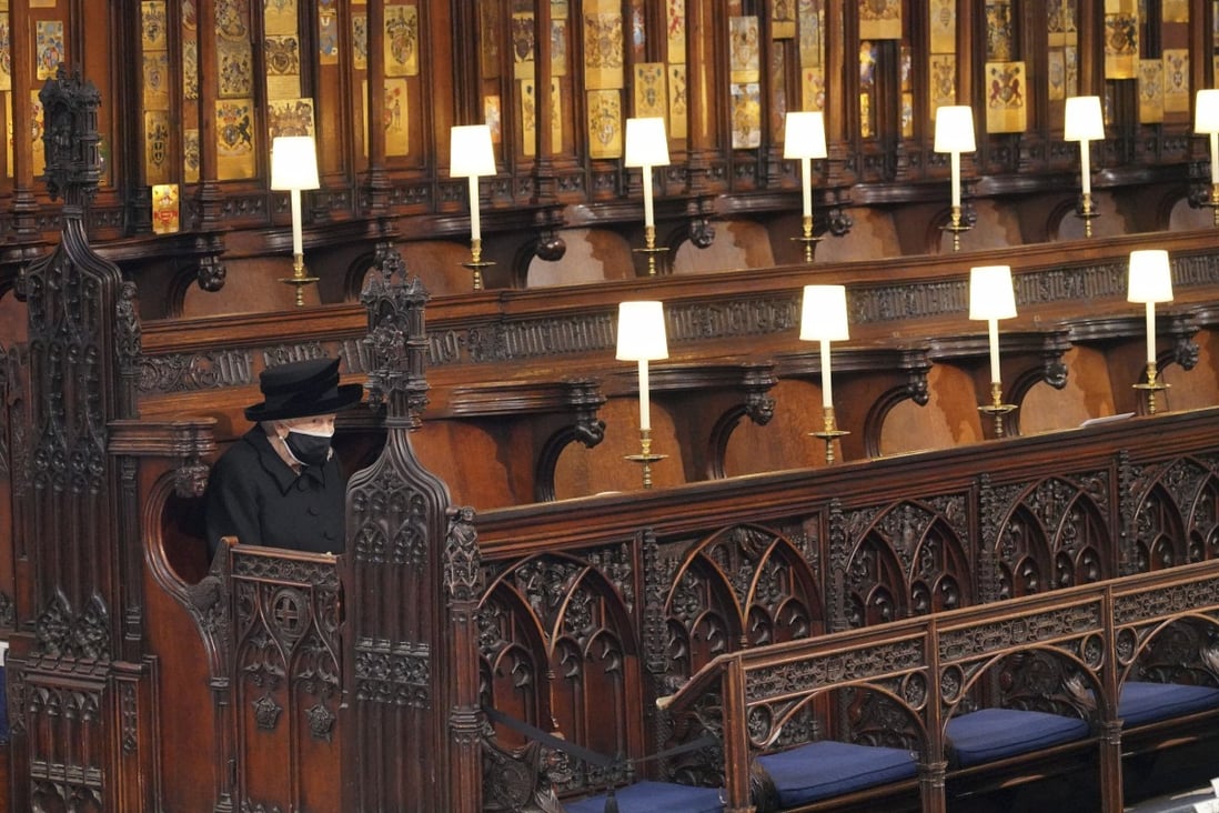 Queen Elizabeth sits alone in St George's Chapel during the funeral of Prince Philip, at Windsor Castle on April 17. The queen, popular with the British public, is the UK’s longest-reigning monarch. Photo: Pool via AP