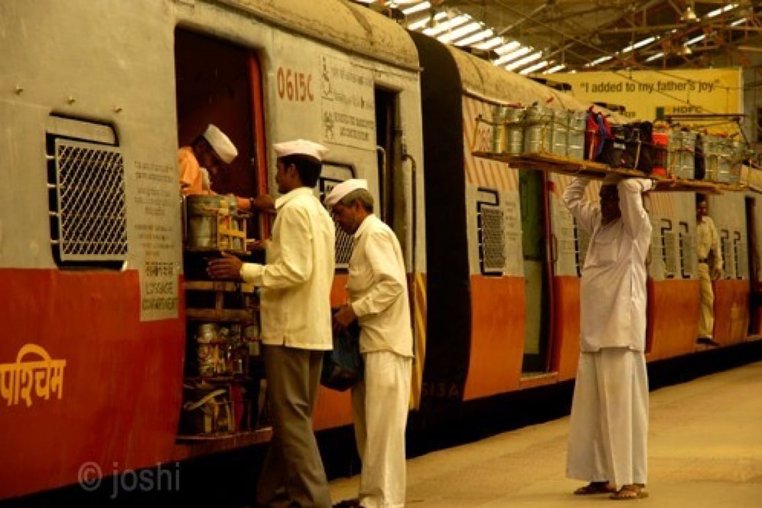 Mumbai's 'dabbawallas' at work loading lunchboxes onto a train. Photo: Handout