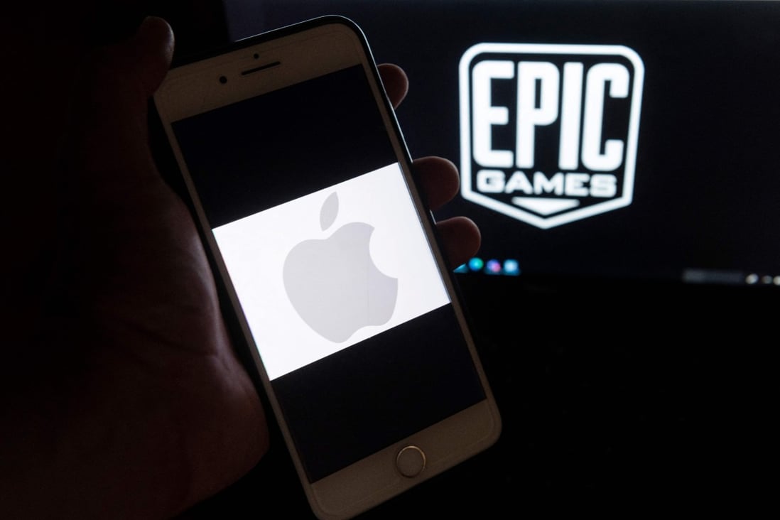 This illustration picture shows the Epic Games logo displayed on a laptop and an Apple Logo on an iPhone. Photo: AFP