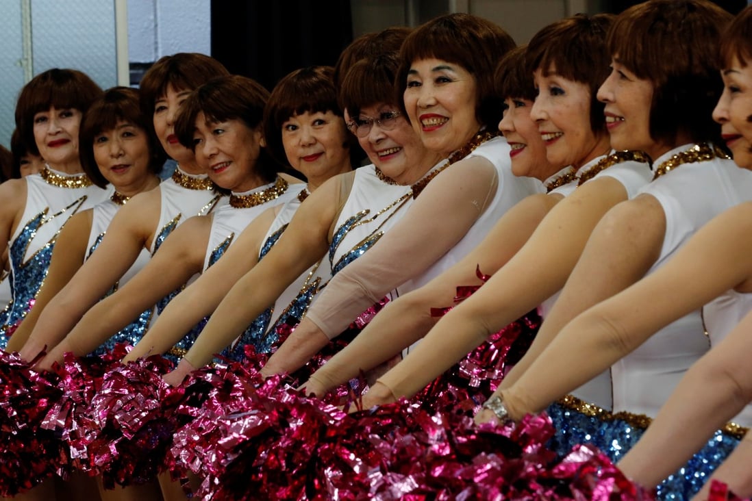 Members of senior cheer squad “Japan Pom Pom” pose for commemorative photos before filming a dance routine for an online performance in Tokyo, Japan, on April 12, 2021. Photo: Reuters