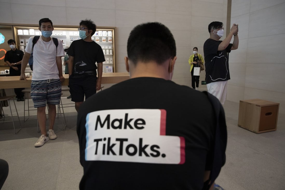 A man wearing a shirt promoting TikTok is seen at an Apple store in Beijing, China, on July 17, 2020. Photo: AP Photo