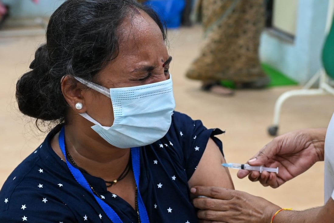 An Indian woman gets inoculated with a dose of the AstraZeneca vaccine. Photo: AFP