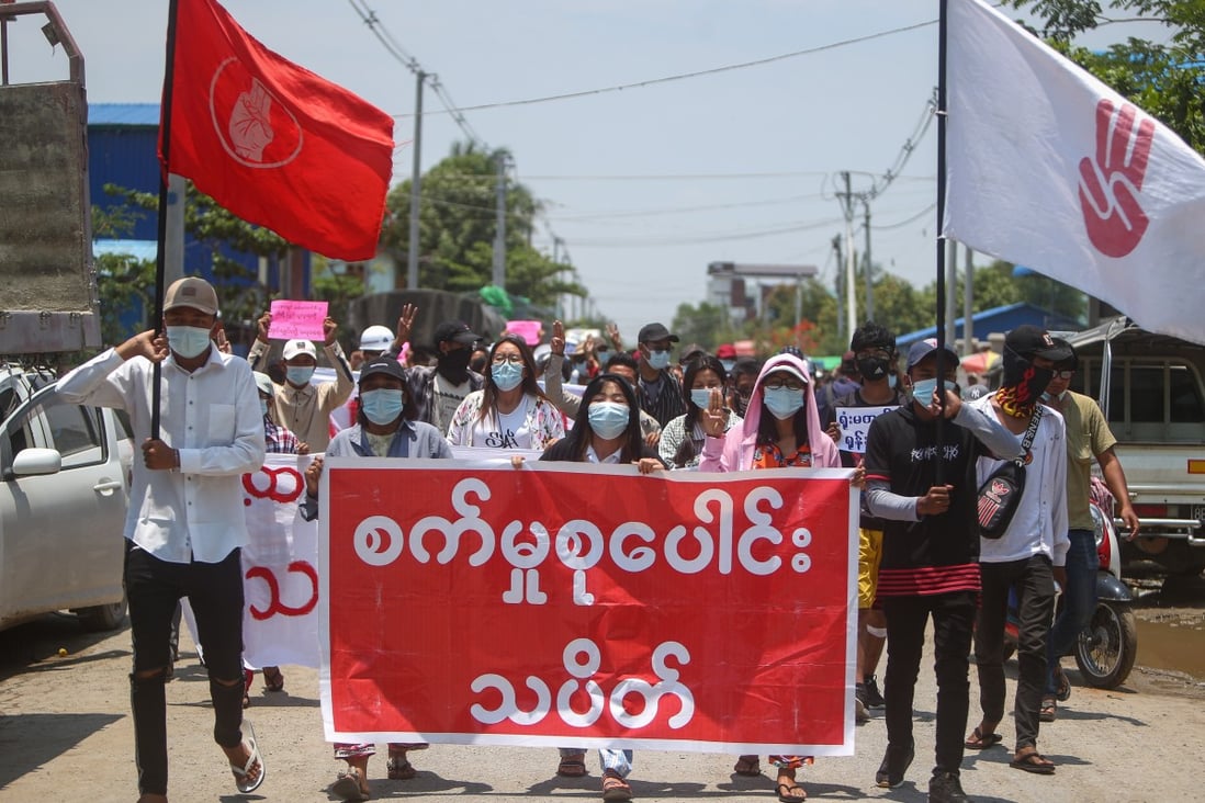 Demonstrators carry a banner that reads “Industrial Strike Group” during a protest in Mandalay. Photo: EPA