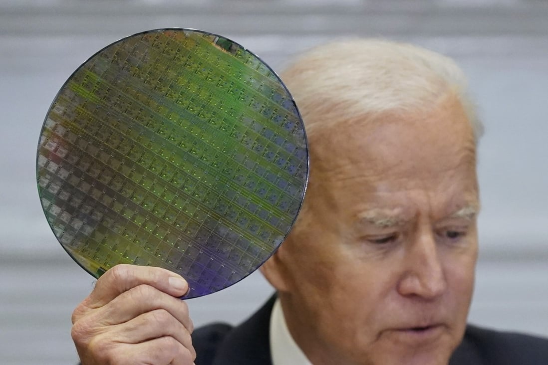 US President Joe Biden holds up a silicon wafer as he participates virtually in the CEO Summit on Semiconductor and Supply Chain Resilience, in the White House on April 12. Photo: AP