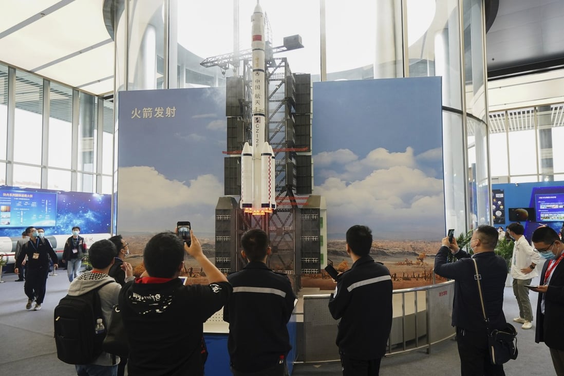 Visitors view a simulated rocket launch on display at an exhibition featuring space science and achievement during the China Space Conference in Nanjing, Jiangsu province, on April 24. Photo: Xinhua via AP