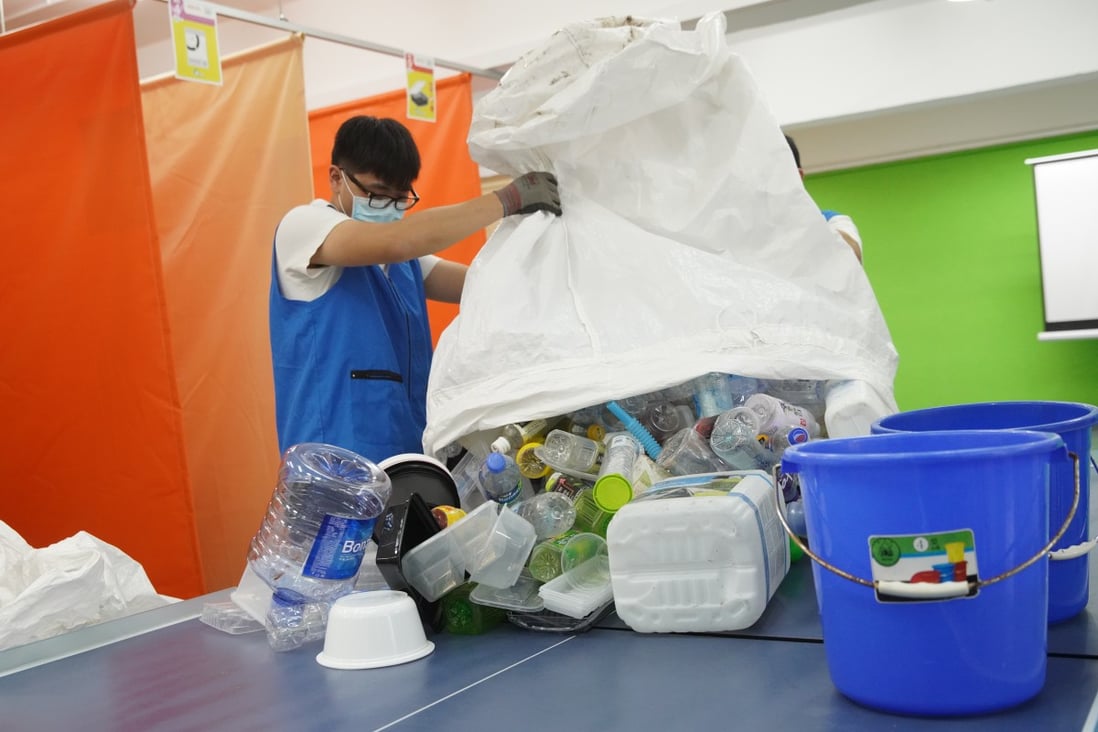 Member of Greeners Action collect waste plastic in Kowloon Bay. Photo: Winson Wong