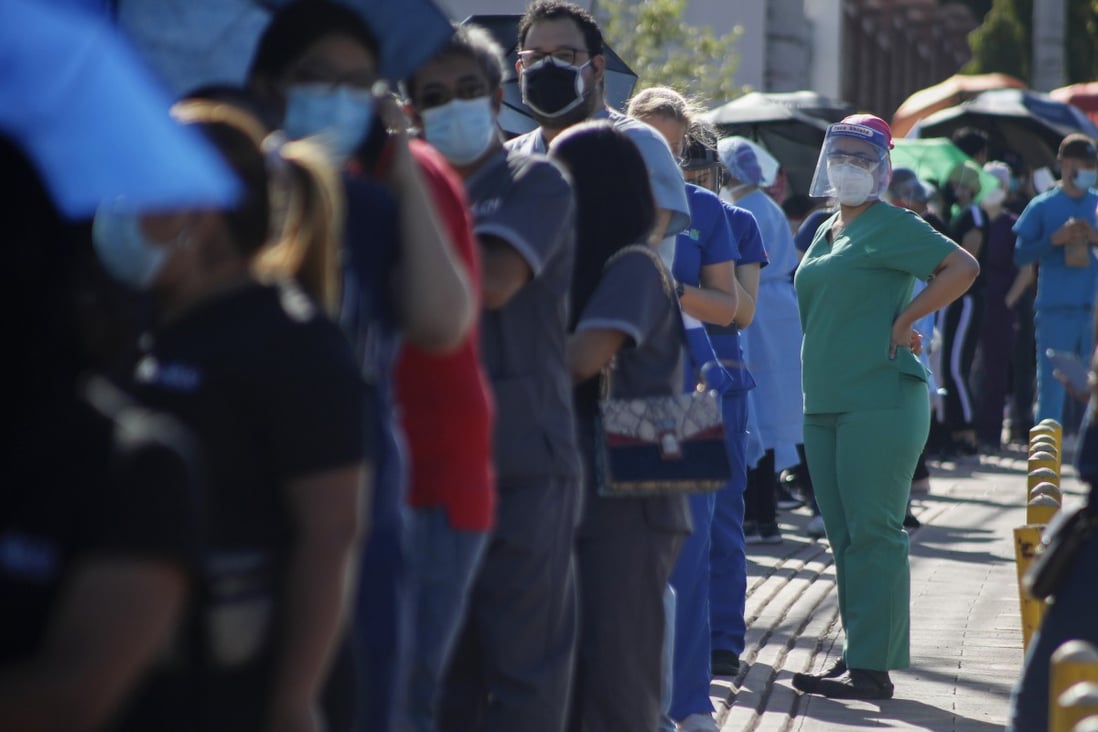Healthcare workers wait to be inoculated in Honduras, where vaccines have been in short supply. Photo: AP