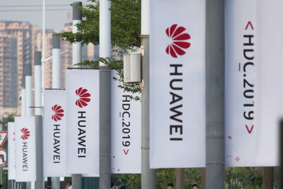Banners with the Huawei logo are seen outside the venue where the telecoms giant unveiled its new HarmonyOS operating system in Dongguan, China, on August 9, 2019. Photo: AFP