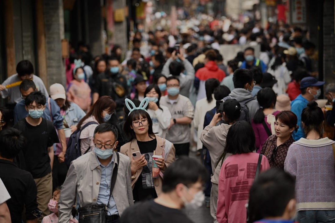 People walk through an alley near Houhai lake in Beijing on May during the Labour Day holidays. Photo: AFP