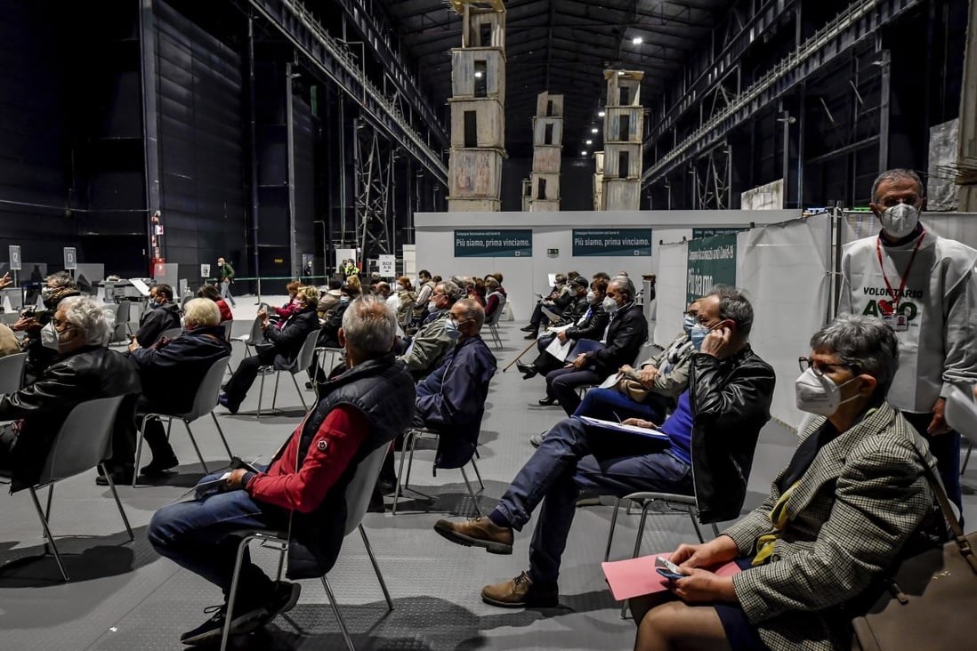 People wait to get their dose of Covid-19 vaccine in Milan, Italy. File photo: LaPresse via AP