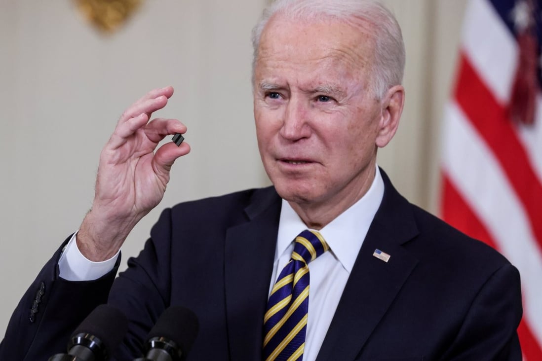 US President Joe Biden holds a chip as he speaks prior to signing an executive order aimed at addressing a global semiconductor shortage, in the State Dining Room at the White House in Washington on February 24. Photo: Reuters