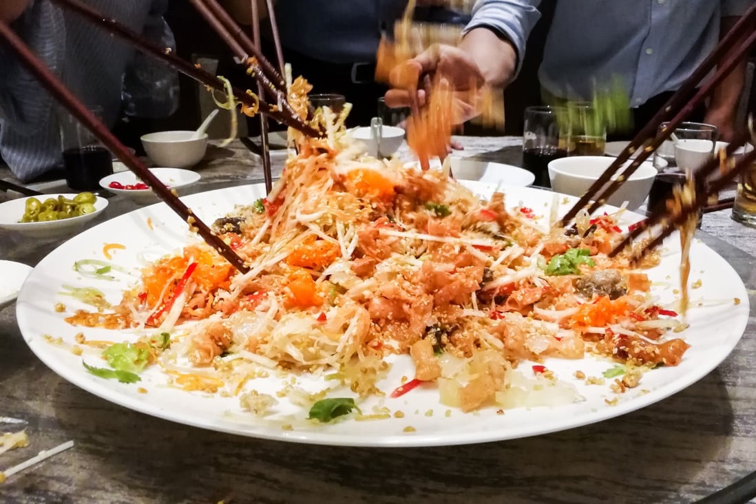 Yee sang salad being tossed during Lunar New Year. Photo: Shutterstock